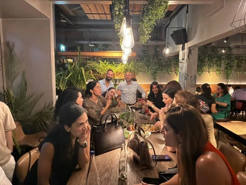 A full room of members in conversation