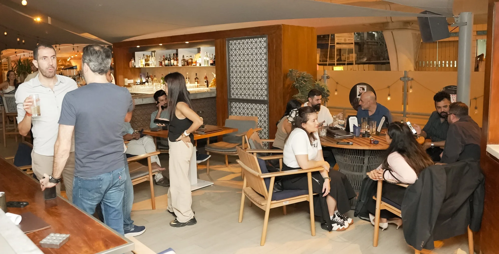 The venue during a Get Together, members talking across several tables